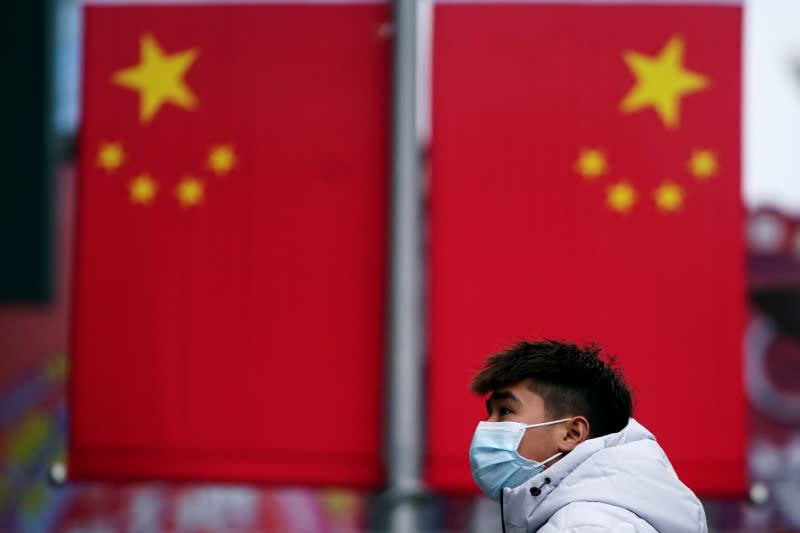 A man wearing a mask is seen at the Nanjing Pedestrian Road, a main shopping area, in Shanghai