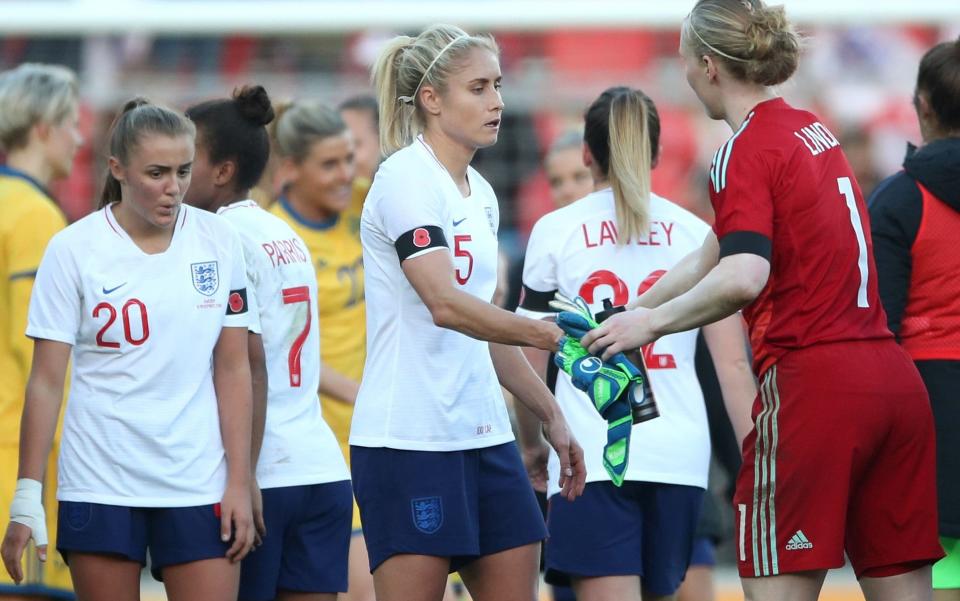 Steph Houghton (centre) picked up her 100th international cap on Sunday, though appeared disappointed following the 2-0 defeat to Sweden in Rotherham - PA