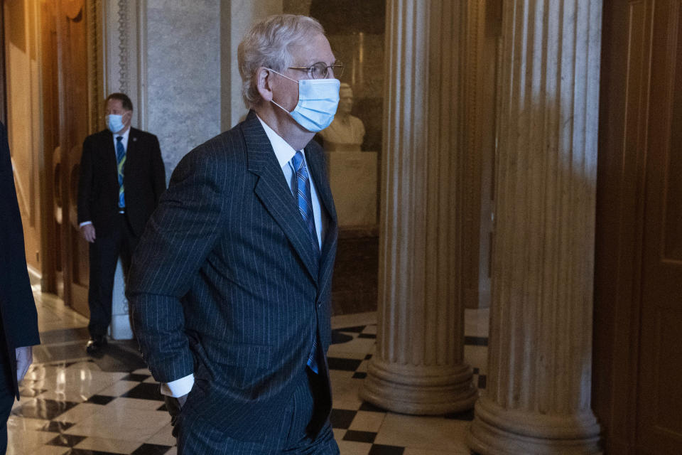 In this Oct. 22, 2020, photo, Senate Majority Leader Mitch McConnell, R-Ky., right, steps out of the Senate chamber on Capitol Hill, in Washington. McConnell says there’s nothing the public needs to know about his health after photos showed what appears to be bruising on his hands and around his mouth. (AP Photo/Jose Luis Magana)