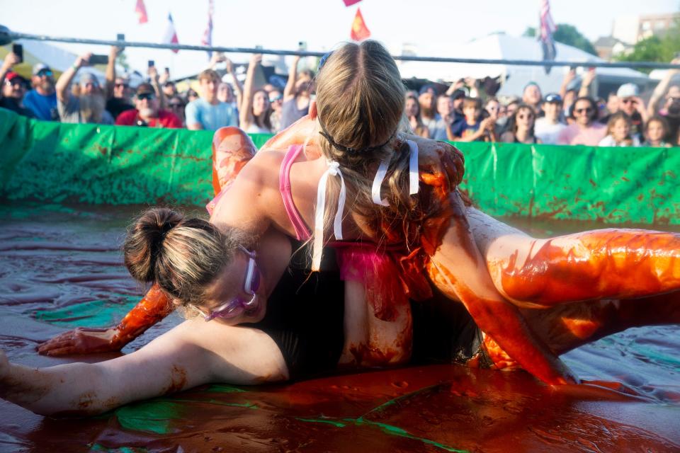 Mariah Garland (above) and Jennifer Justice (below) wrestle in sauce during the Memphis in May World Championship Barbecue Cooking Contest at Tom Lee Park in Downtown Memphis on Wednesday, May 17, 2023. Participants, both amateurs and professionals, wrestled in barbecue sauce 