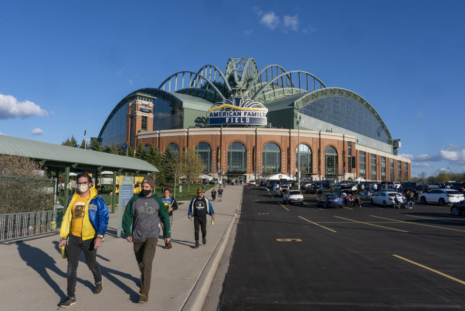 FILE - Fans are pictured outside American Family Field before a baseball game between the Milwaukee Brewers and the Chicago Cubs, April 12, 2021, in Milwaukee. Proposals for new and improved sports stadiums are proliferating across the U.S. — and could come with a hefty price tag for taxpayers. (AP Photo/Morry Gash, File)