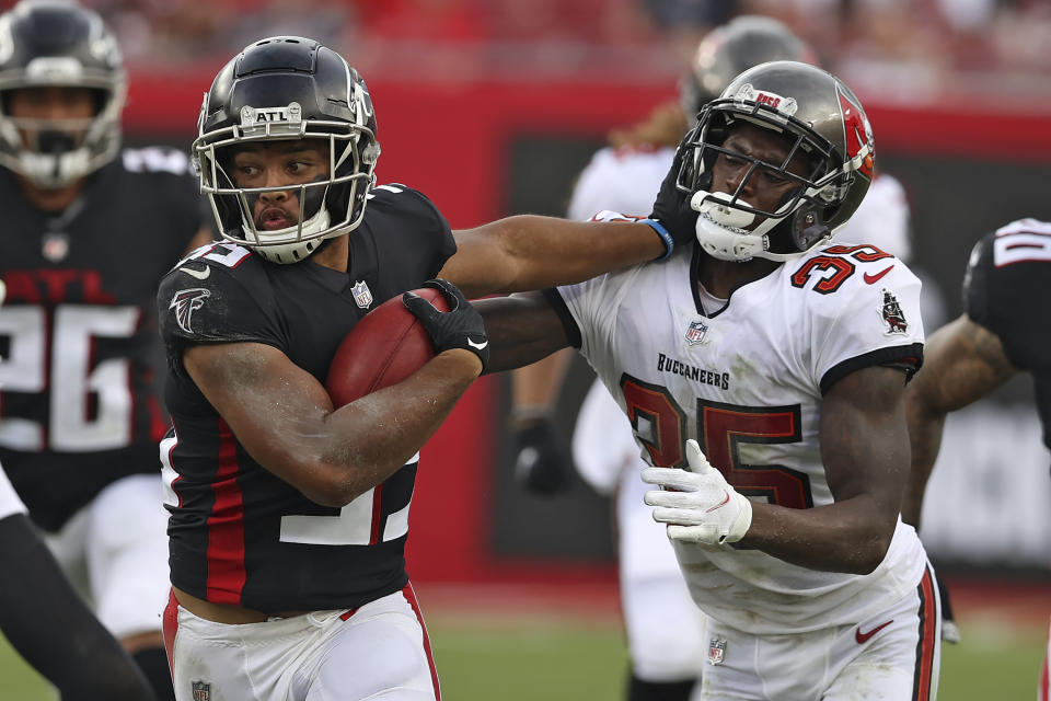 Atlanta Falcons' Avery Williams, left, stiff arms Tampa Bay Buccaneers defensive back Jamel Dean on a punt return during the second half of an NFL football game Sunday, Sept. 19, 2021, in Tampa, Fla. (AP Photo/Mark LoMoglio)