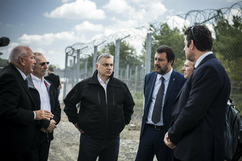 In this handout photo provided by the Hungarian Prime Minister's Press Office shows Hungarian Prime Minister Viktor Orban, center, Italian Interior Minister Matteo Salvini, third right, and Hungarian Interior Minister Sandor Pinter, second left, during their visit at the Hungarian-Serbian border near Roszke, 180 kms southeast of Budapest, Hungary, Thursday, May 2, 2019. (Balazs Szecsodi/Hungarian Prime Minister's Press Office/MTI via AP)