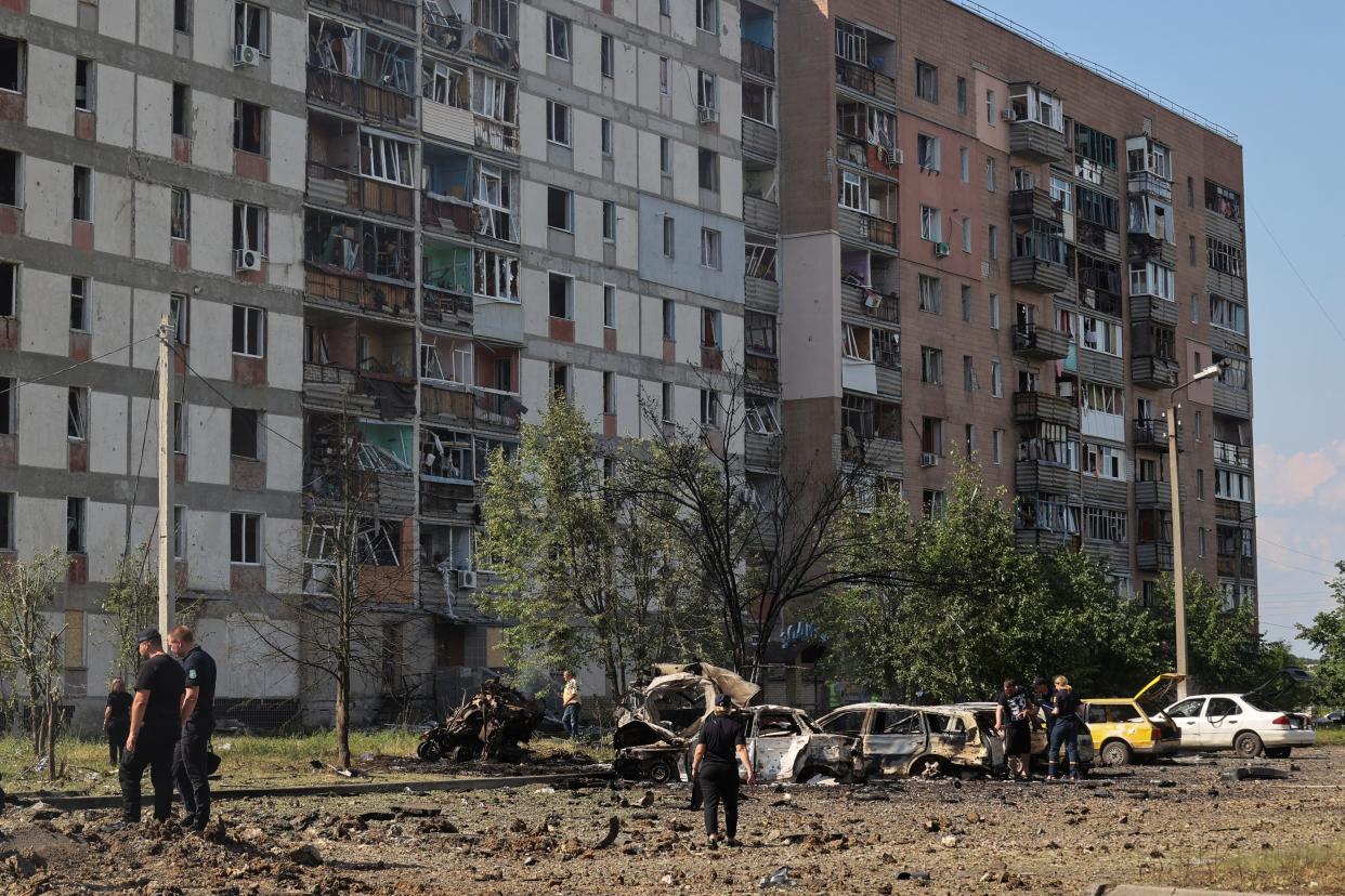 Police investigators work at a site of a Russian military strike in the town of Pervomaiskyi (REUTERS)