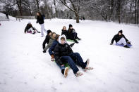 Youngs enjoy sliding on the abundant snow in Soendermarken, Frederiksberg in Copenhagen, Wednesday Jan. 17 2024. (Nils Meilvang/Ritzau Scanpix via AP)