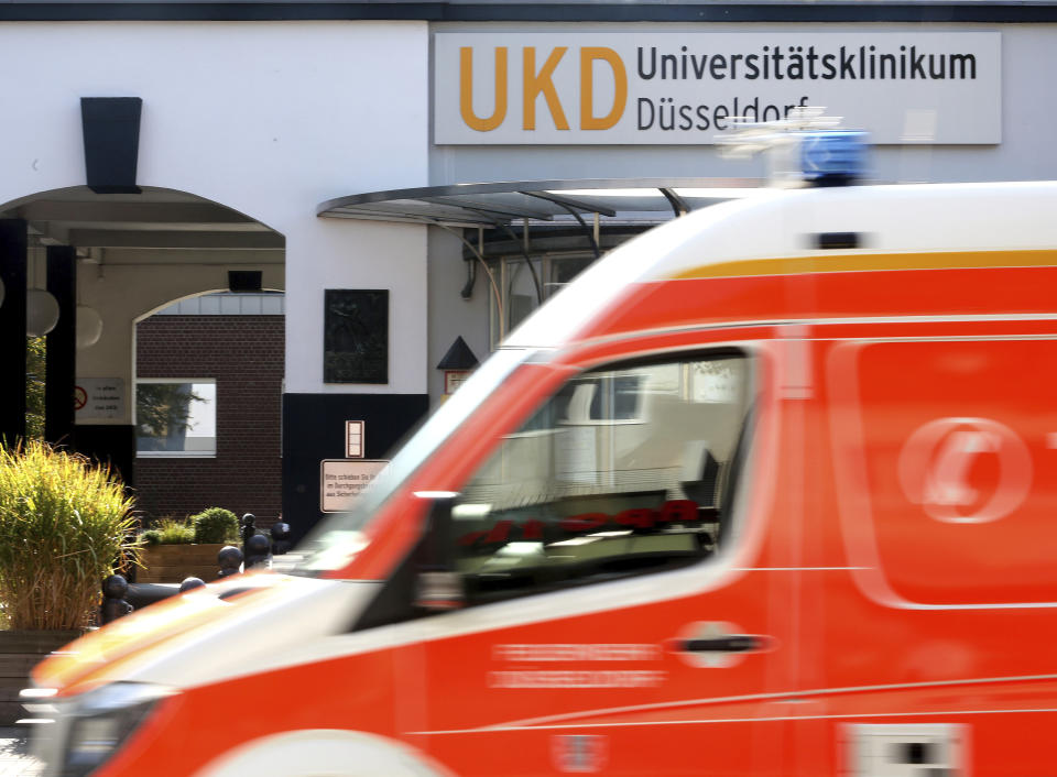 An ambulance drives past the University Hospital in Duesseldorf, Germany, Tuesday, Sept. 15, 2020. German authorities say a hacker attack caused the partial failure of IT systems at a major hospital in Duesseldorf, and a woman who needed urgent admission died after she had to be taken to another city for treatment. (Roland Weihrauch/dpa via AP)