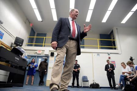 U.S. Representative Ted Yoho (R-FL) answers questions from reporters after a town hall meeting at Abraham Lincoln Middle School in Gainesville, Florida, U.S., April 10, 2017. REUTERS/Phelan Ebenhack