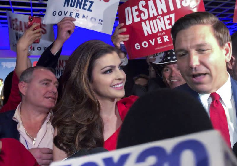 Republican political operative Lev Parnas stands behind Ron DeSantis and his wife Casey after DeSantis was elected governor in 2018