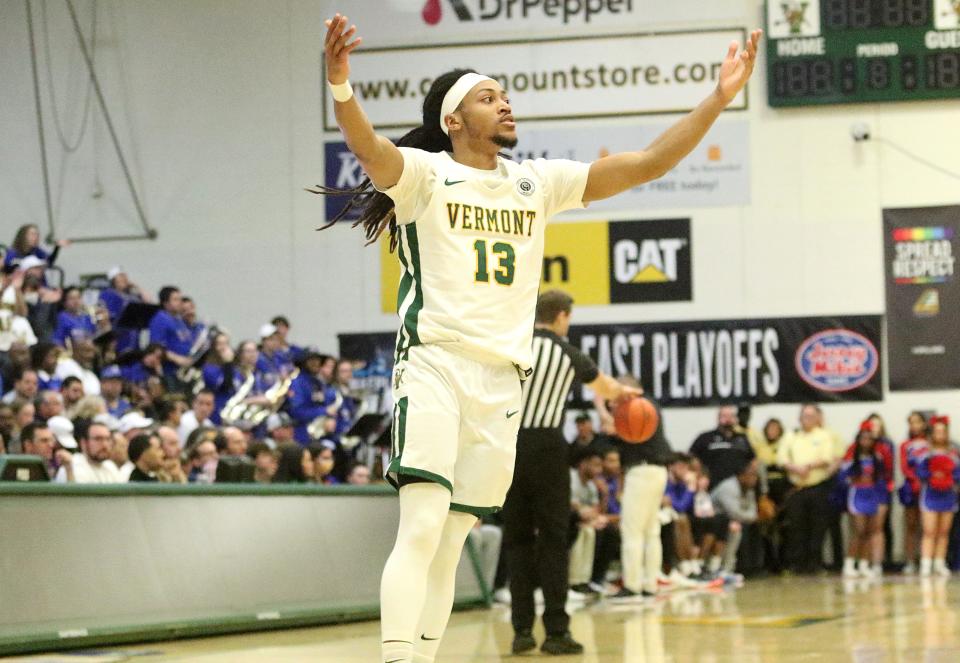 Vermont's Dylan Penn encourages the crowrd to get loud as the final seconds tick away in the Catamounts 72-59 win over UMass Lowell in the America East title game on Saturday afternoon at Patrick Gym.