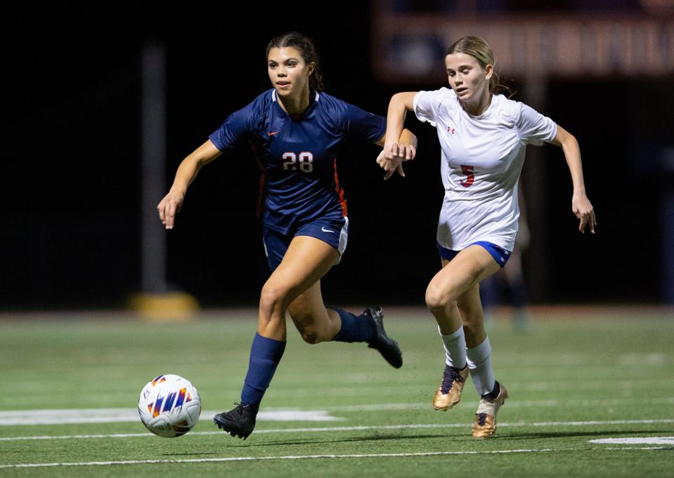 Benjamin's Sam Woods, left, moves the ball past King's Academy Coco Joos during their playoff soccer game on February 9, 2024 Palm Beach Gardens, Florida.