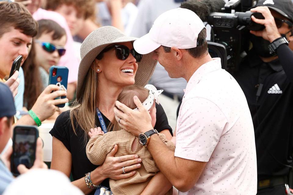 Rory McIlroy of Northern Ireland celebrates with his wife Erica and daughter Poppy at the 2021 Wells Fargo Championship in Charlotte, North Carolina
