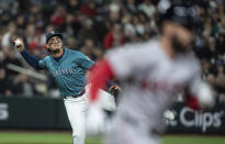 Seattle Mariners second baseman Josh Rojas attempts to throw out Boston Red Sox's Connor Wong after fielding a bunt during the fifth inning of a baseball game, Saturday, March 30, 2024, in Seattle. Wong was safe on the play. (AP Photo/Stephen Brashear)