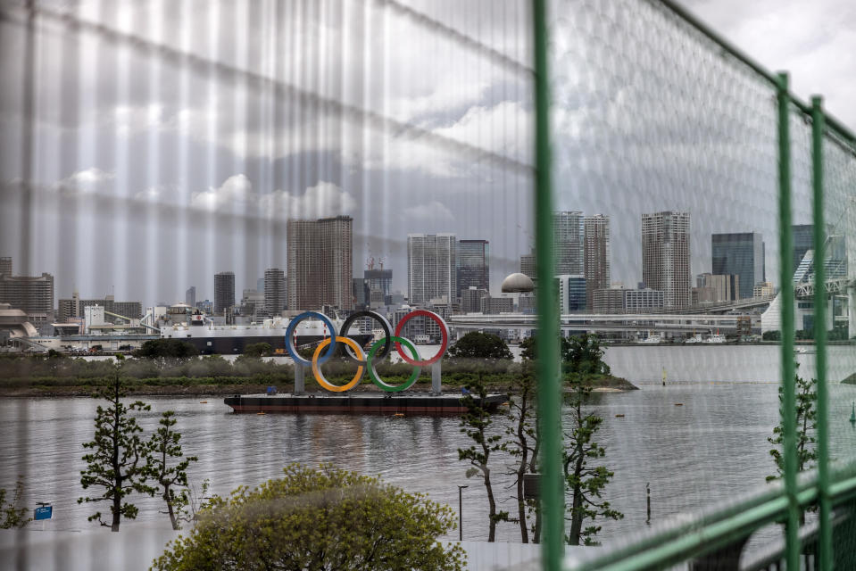 <p>TOKYO, JAPAN - AUGUST 02: The Olympic Rings are seen through a security fence surrounding Odaiba Marine Park Olympic venue on August 2, 2021 in Tokyo, Japan. Despite a recent surge in Covid-19 cases in Tokyo, Japanese Prime Minister Yoshihide Suga stated on Friday that adequate measures are in place to prevent coronavirus infections spreading from Olympic athletes and staff to the wider population. Mr. Suga also announced that Tokyo's neighboring prefectures of Chiba, Kanagawa, Saitama will be added to the state of emergency that currently covers the capital and which runs through to August 31st. (Photo by Carl Court/Getty Images)</p> 