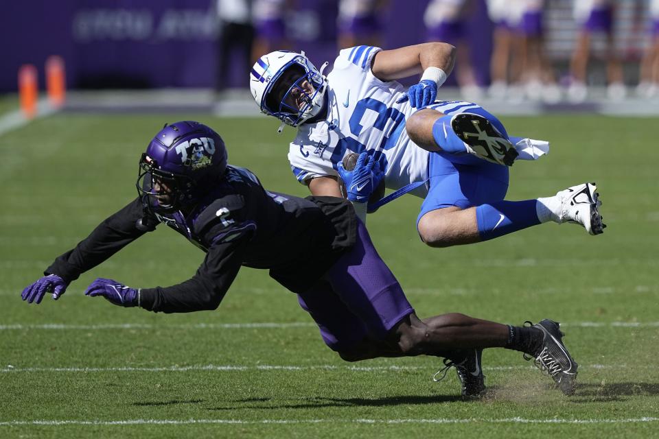 BYU tight end Isaac Rex (83) is upended by TCU cornerback Josh Newton (2) after the catch during the first half of an NCAA college football game Saturday, Oct. 14, 2023, in Fort Worth, Texas. | LM Otero, Associated Press