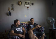 Partners Lázaro “Lachi” González, right, and Adiel González give an interview at their home in Matanzas, Cuba, Thursday, Oct. 7, 2021. The socialist government recently published a draft Family Law and asked for public comment ahead of a referendum on legalizing same-sex marriage, as well as expanding grandparents rights, allowing for prenuptial agreements and in cases of divorce, create financial consequences for those who have committed gender violence, amid a total of 480 articles. (AP Photo/Ramon Espinosa)