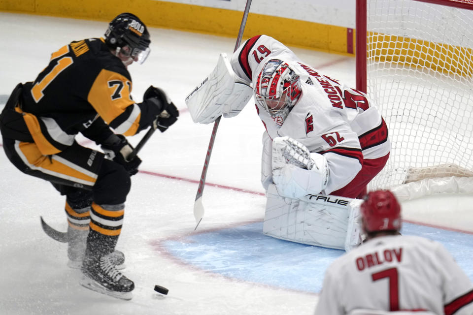 Pittsburgh Penguins' Evgeni Malkin (71) can't get his stick on a rebound off Carolina Hurricanes goaltender Pyotr Kochetkov (52) during the first period of an NHL hockey game in Pittsburgh, Tuesday, March 26, 2024. (AP Photo/Gene J. Puskar)