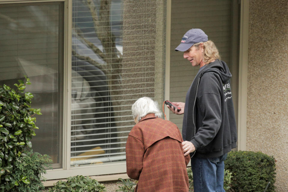 Dorothy Campbell and her son, Charlie Campbell, talk through a window with her husband, Gene Campbell, at the Life Care Center of Kirkland, the long-term care facility linked to several confirmed coronavirus cases in the state, in Kirkland, Washington, U.S. March 5, 2020.  REUTERS/David Ryder