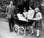 <p>The Royal Couple and a young Prince Andrew, looking up curiously from his pram (1960). Prince Andrew is the couple's third child, after Charles and Anne.</p> 
