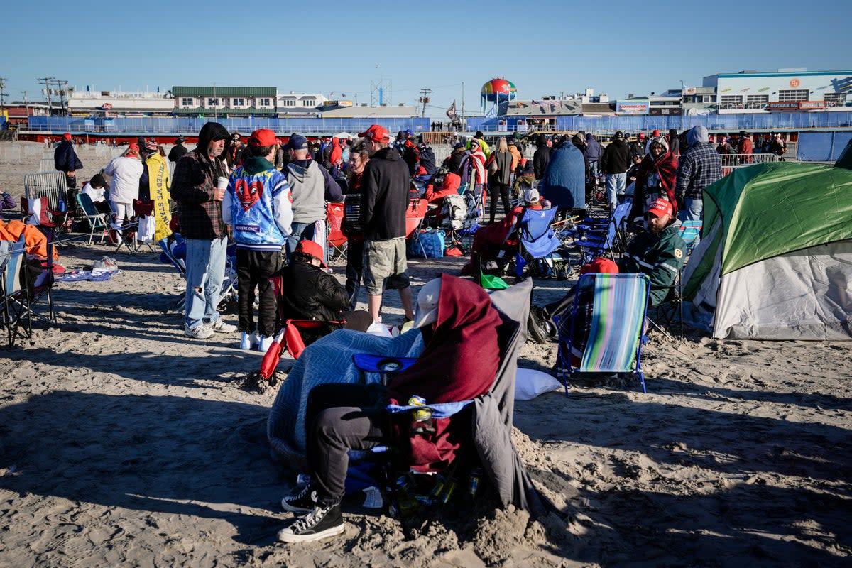 Some fans of Mr Trump came prepared, decked out in warm clothing and sitting in camp chairs. Others had even erected tents for overnight stays (AP)