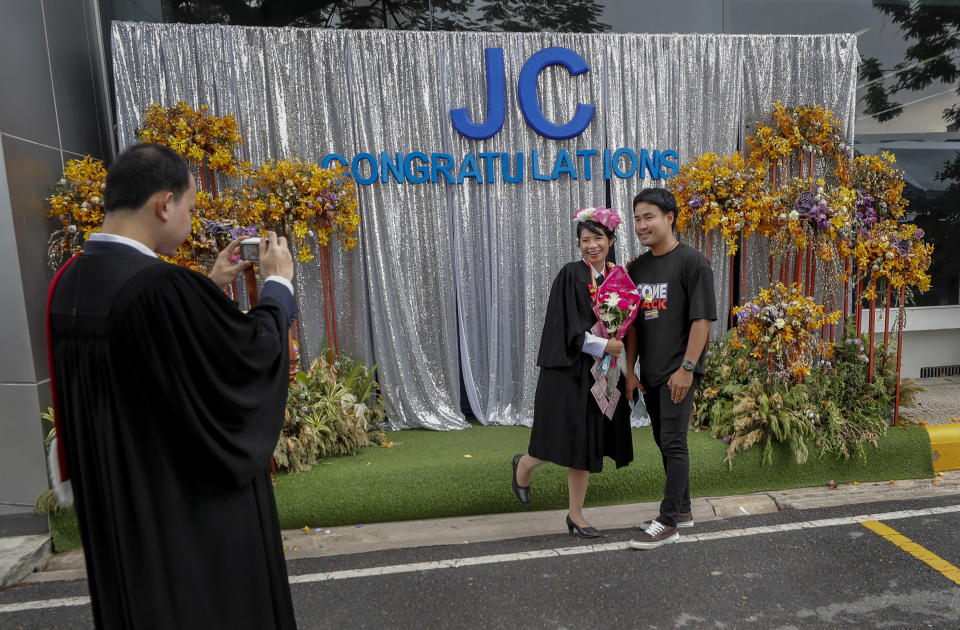 A university student poses for a photo ahead of a graduation ceremony at the Thammasat University, Friday, Oct. 30, 2020, Bangkok, Thailand. (AP Photo/Sakchai Lalit)