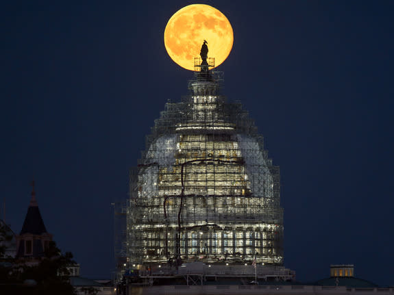 The second full moon of July 2015, a so-called Blue Moon, rises behind the dome of the U.S. Capitol in this amazing view by NASA photographer Bill Ingalls in Washington, D.C. on July 31, 2015.
