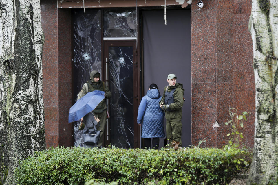 Soldiers guard the entrance of a government building in Donetsk, the capital of the self-proclaimed Donetsk People's Republic in eastern Ukraine on Oct. 20, 2022.  (Alexei Alexandrov / AP)