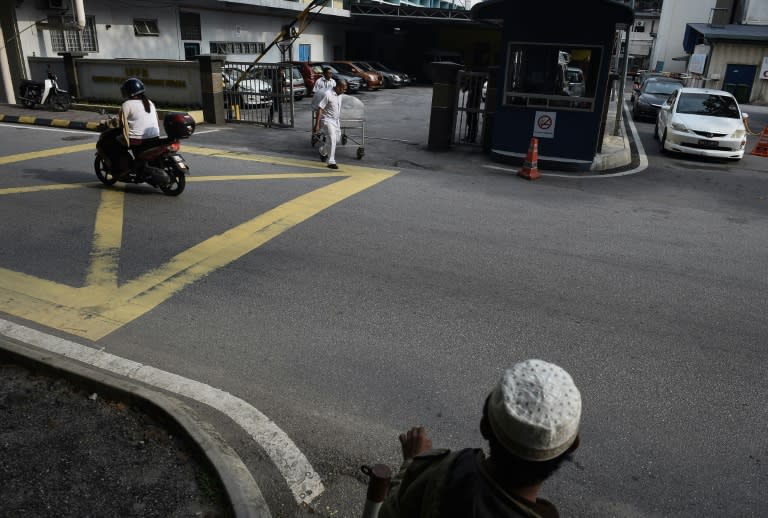 Workers move a body cart through the gate of the forensics wing of the Hospital Kuala Lumpur where the body of Kim Jong-Nam is being held