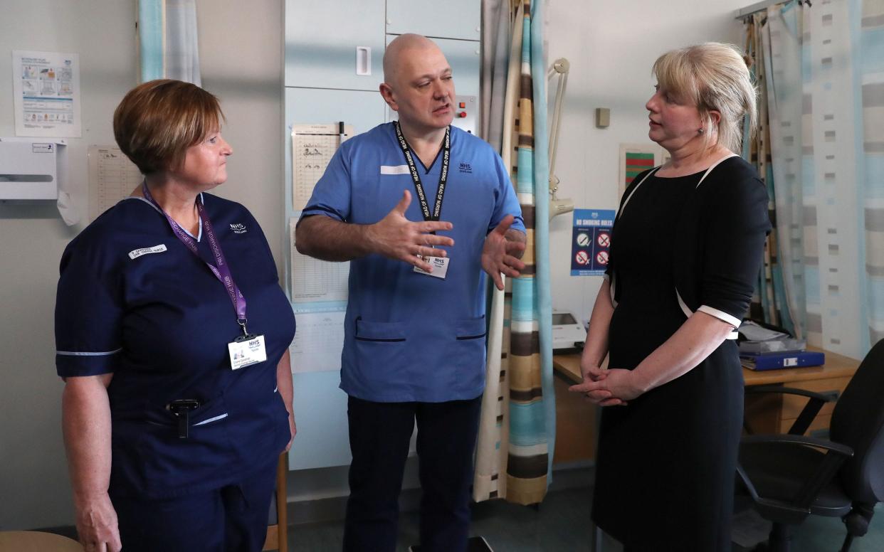 Scottish Health Minister Shona Robison chats with Head of Nursing Brendan Forman and Senior Charge Nurse Diane Gardiner whilst visiting Perth Royal Infirmary - PA