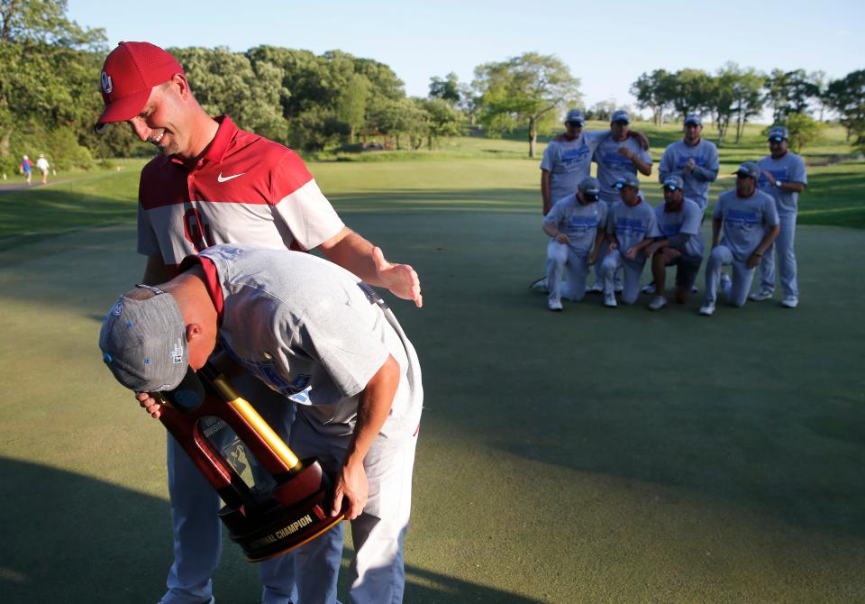 OU coach Ryan Hybl, left, stands with a Max McGreevy after the Sooners won the NCAA men's golf title over Oregon in 2017 in Sugar Grove, Ill.