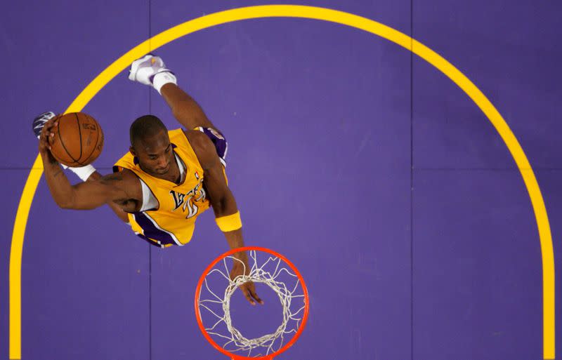 FILE PHOTO: Lakers Kobe Bryant goes up for a dunk against the New York Knicks during their NBA basketball game in Los Angeles