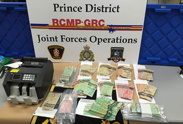 Items seized included about 80 grams of cocaine and more than $60,000 in cash. (RCMP - image credit)