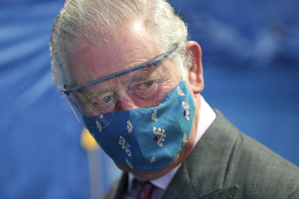 FILE - Britain's Prince Charles, wearing a face mask to protect against coronavirus, arrives to meet with front line health and care workers administering and receiving the COVID-19 vaccine during a visit to the Gloucestershire Vaccination Centre at Gloucestershire Royal Hospital, in Gloucestershire, England, Dec. 17, 2020. The announcement on Monday Feb. 5, 2024 that King Charles III has been diagnosed with cancer has come as a shock to many in Britain, largely because the 75-year-old monarch has generally enjoyed good health through the years. (Chris Jackson/Pool Photo via AP, File)