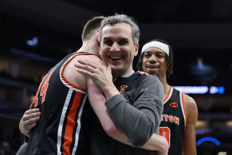 Princeton Tigers head coach Mitch Henderson celebrates the victory against the Arizona Wildcats with guard Matt Allocco (14) at Golden 1 Center in Sacramento on March 16, 2023.