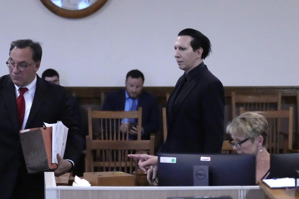 Musical artist Marilyn Manson, whose legal name is Brian Hugh Warner, right, arrives with his attorney Kent Barker during an appearance in Belknap Superior Court,Monday, Sept. 18, 2023, in Laconia, N.H. Manson, who was charged with charged with two misdemeanor counts of simple assault, was accused of approaching a videographer at his 2019 concert in New Hampshire and allegedly spitting and blowing his nose on her. (AP Photo/Charles Krupa)