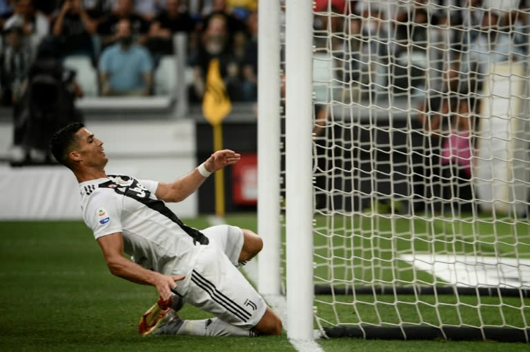 Cristiano Ronaldo slips towards the goal after missing a chance to score hist first goal for Juventus against Lazio