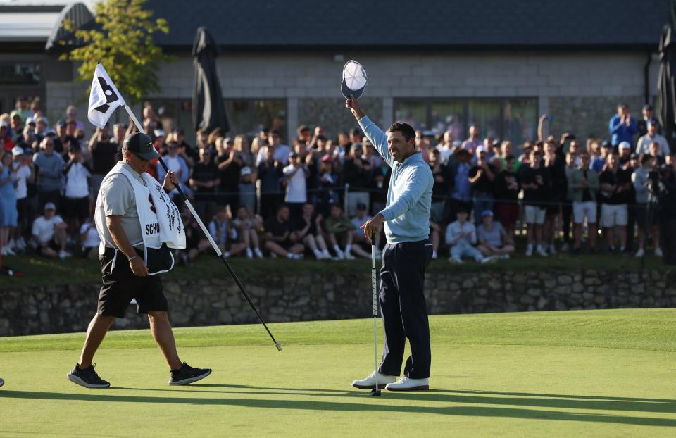 Charl Schwartzel celebrates on the 18th green after winning the inaugural LIV golf series event in London.