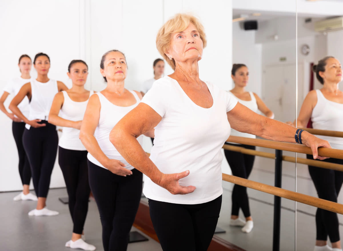 senior woman leading a ballet class in studio