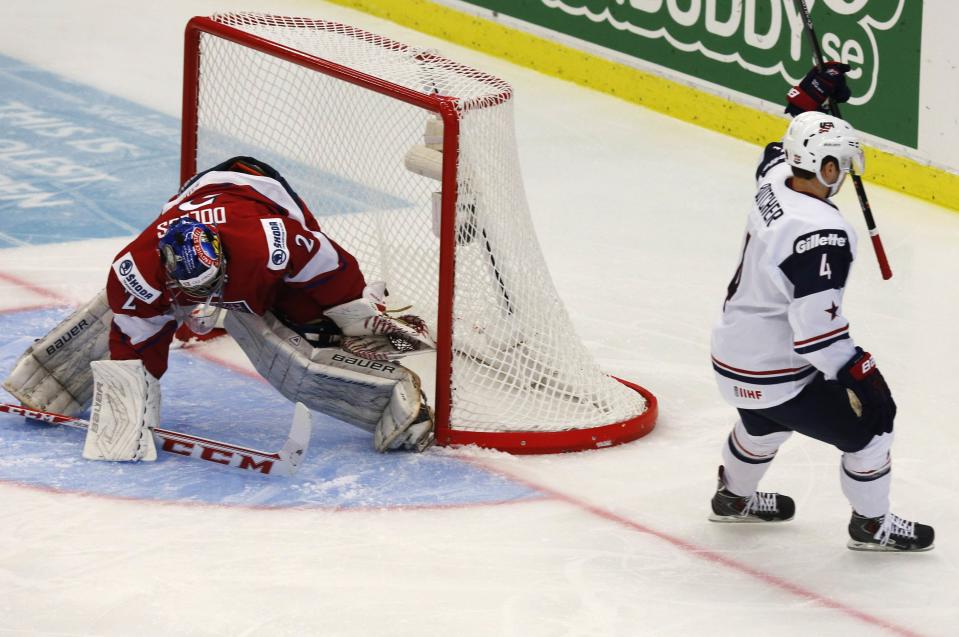 Will Butcher (R) of the U.S. scores on Czech Republic's goalie Daniel Dolejs during the first period of their IIHF World Junior Championship ice hockey game in Malmo, Sweden, December 26, 2013. REUTERS/Alexander Demianchuk (SWEDEN - Tags: SPORT ICE HOCKEY)