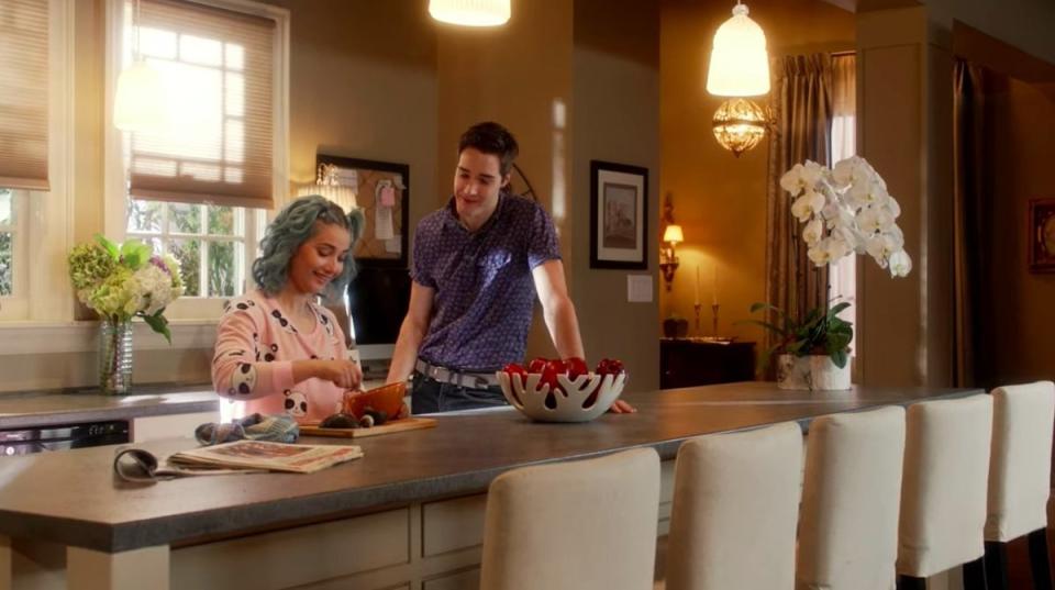 A couple sitting in a fully furnished kitchen