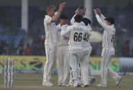 New Zealand's Kyle Jamieson, left, celebrates the wicket of India's Shubman Gill with his teammates during the day three of their first test cricket match in Kanpur, India, Saturday, Nov. 27, 2021. (AP Photo/Altaf Qadri)
