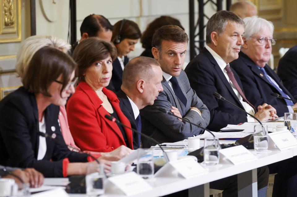 French President Emmanuel Macron, center, attends a meeting with officials from Western and Arab nations, the United Nations and nongovernmental organizations at the Elysee Palace, in Paris, Thursday, Nov. 9, 2023. Macron has opened a Gaza aid conference with an appeal for Israel to protect civilians, saying that "all lives have equal worth" and that fighting terrorism "can never be carried out without rules." (Ludovic Marin, Pool via AP)