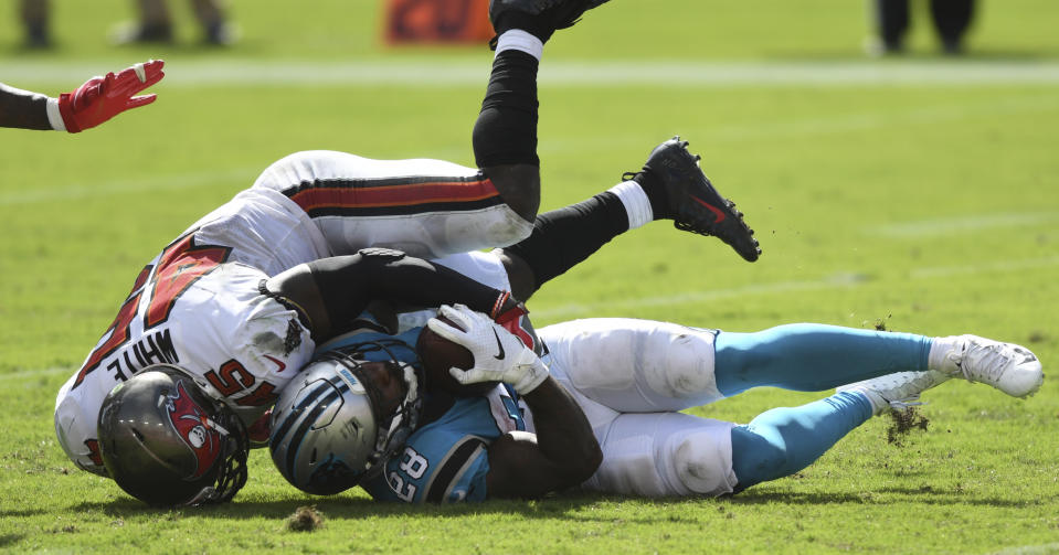 Carolina Panthers running back Mike Davis (28) gets taken down by Tampa Bay Buccaneers linebacker Devin White during the second half of an NFL football game Sunday, Sept. 20, 2020, in Tampa, Fla. (AP Photo/Jason Behnken)