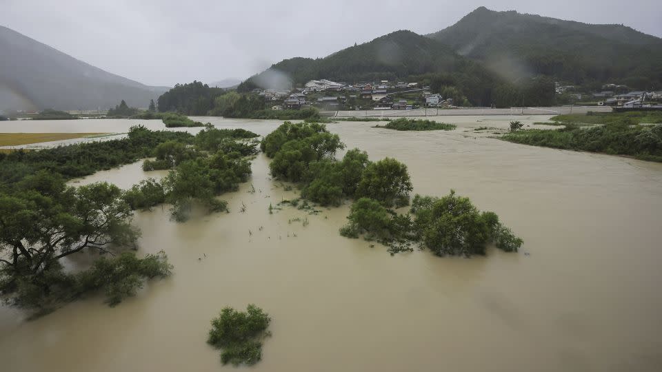 A swollen river as Typhoon Lan makes landfall in Shingu City, Wakayama Prefecture on Tuesday. - Takumi Harada/The Yomiuri Shimbun/AP