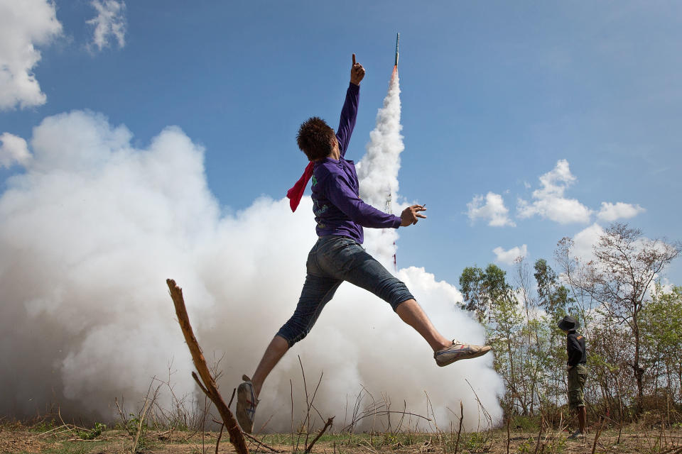 A man cheers as his home-made rocket takes off at the Bun Bang Fai Rocket Festival, marking the beginning of the rainy season on May 10 in Yasothon, Thailand.