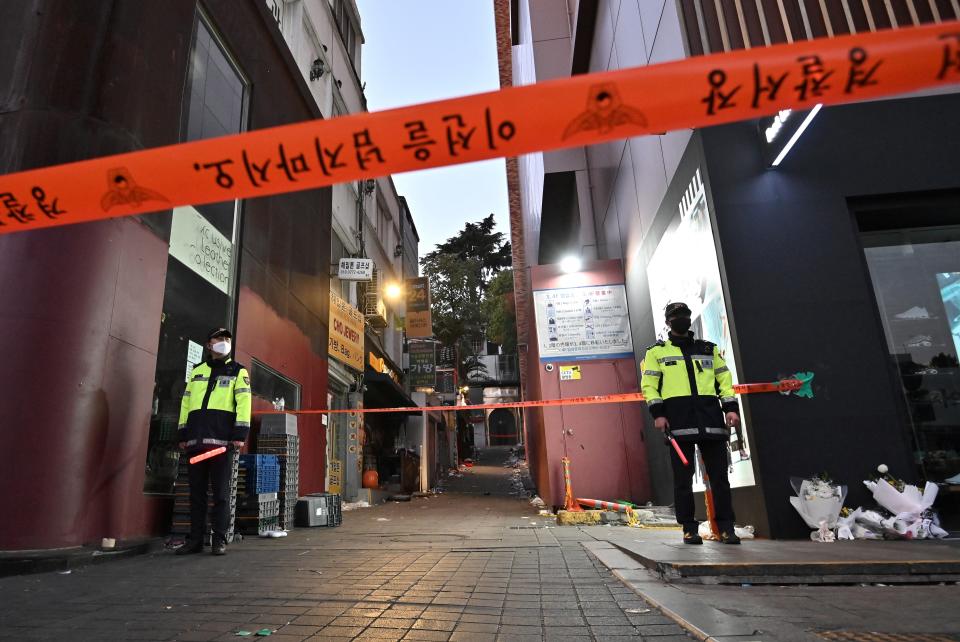 Police stand guard at the cordoned scene of the deadly Halloween crowd surge in the district of Itaewon in Seoul on 1 November 2022 (AFP via Getty Images)