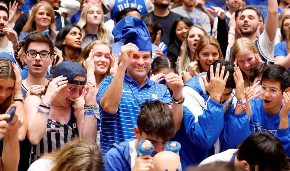 New Duke football coach Manny Diaz stands amongst the Cameron Crazies during the second half of Duke’s 80-56 victory over Charlotte at Cameron Indoor Stadium in Durham, N.C., Saturday, Dec. 9, 2023.