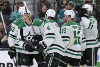 Dallas Stars left wing Jason Robertson, second from left, is congratulated by teammates for his goal against the San Jose Sharks during the second period of an NHL hockey game in San Jose, Calif., Tuesday, March 26, 2024. (AP Photo/Jeff Chiu)