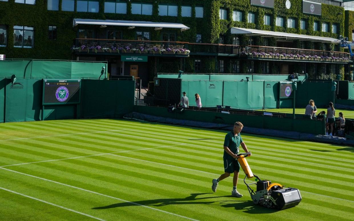 Ground staff make final preparations for day two of Wimbledon. In future years, they could be helping to prepare hybrid grass - Zac Goodwin/PA wire