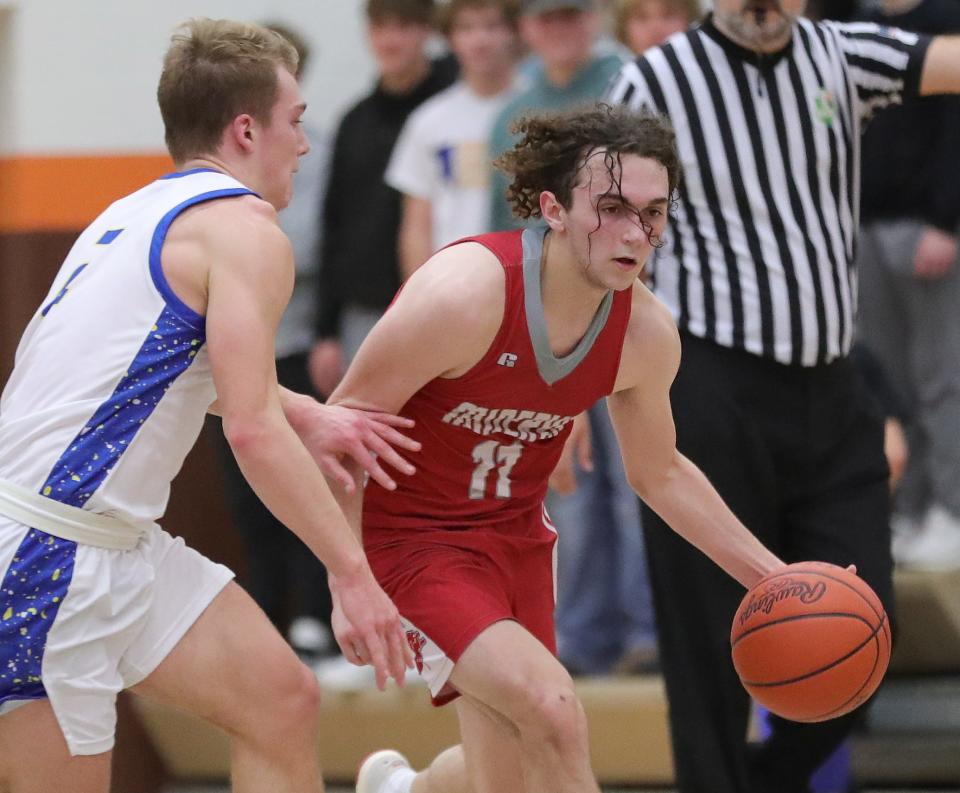 Minerva's Jayden Yerger, right, drives against Maysville's Wesley Armstead during a district semifinal, Wednesday, March 6, 2024, at Claymont High School.