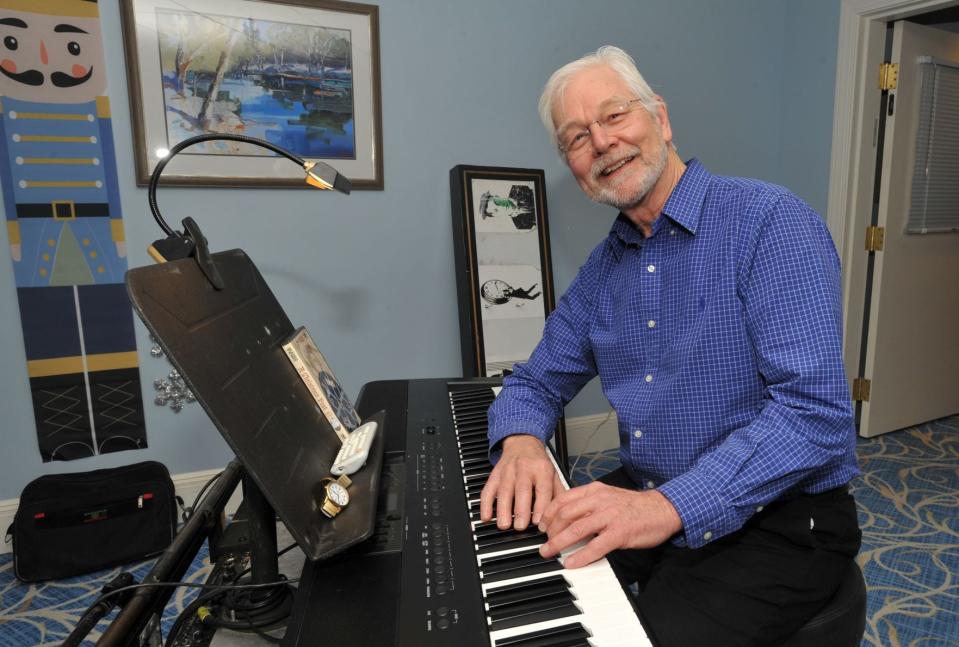 Richard Hughes poses at his piano where he provides music for the 1916 silent movie, "Santa Claus" at the Allerton House in Weymouth, Sunday, Dec. 11, 2022. Tom Gorman/For The Patriot Ledger